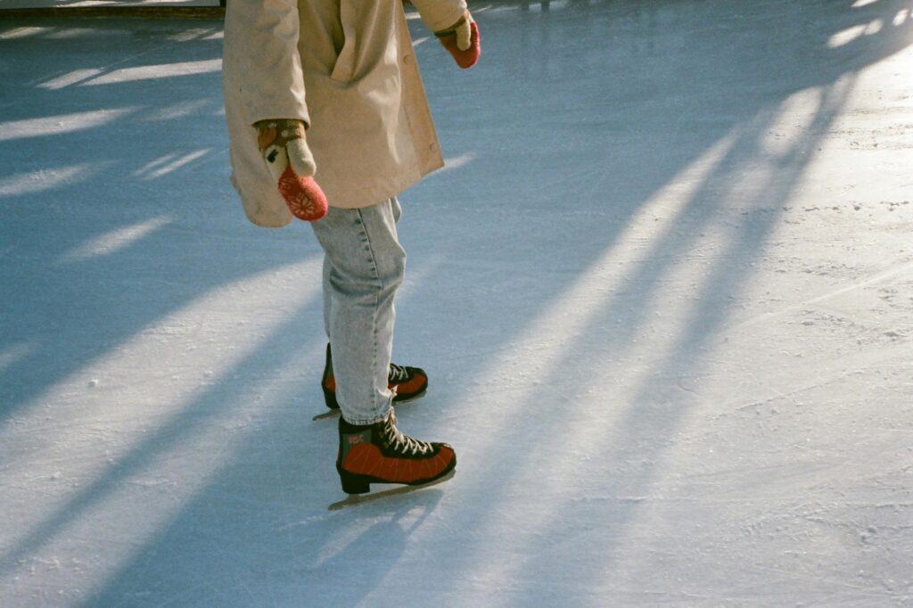 A cropped photo of a child in an ice rink