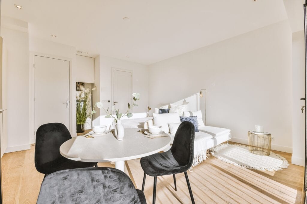 A dining area and living room in a modern flat