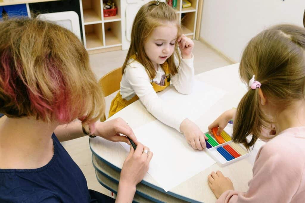 A teacher and her young students in an arts class
