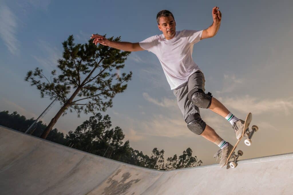 An adult skateboarder in a skate park