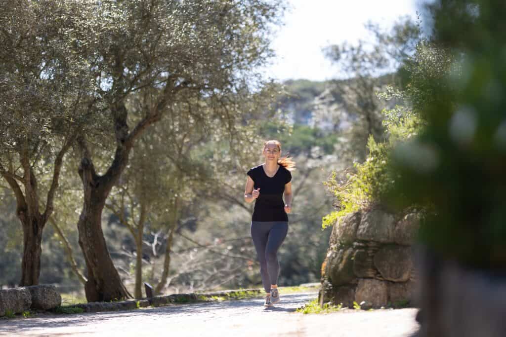 An adult woman jogging in a park