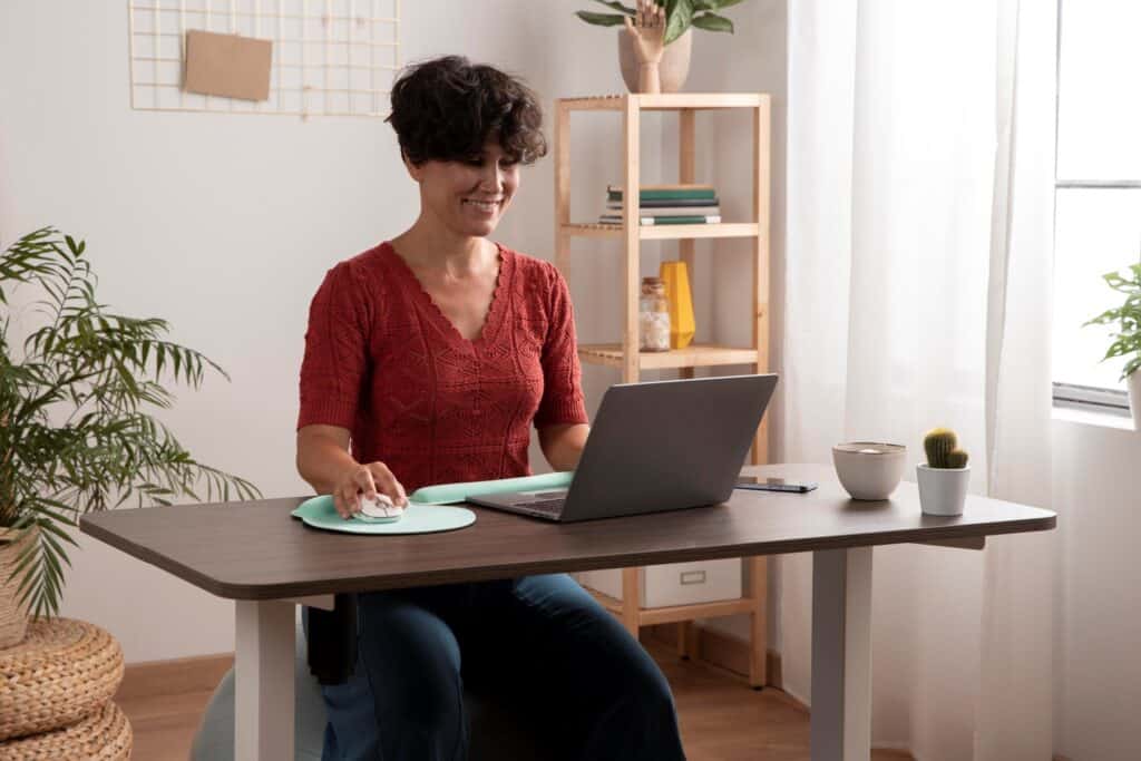 A woman working remotely via home office setup