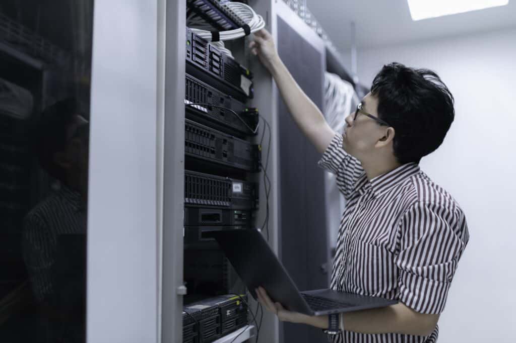A network engineer checking IT servers in the concept of 'how to pack office equipment and furniture'.
