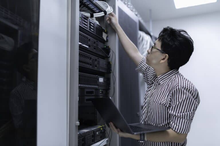 A network engineer checking IT servers in the concept of 'how to pack office equipment and furniture'.