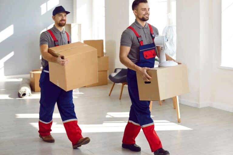Two office removals crew carrying cardboard from an office in the concept of 'How Do Office Removals Services Operate in Streatham'.