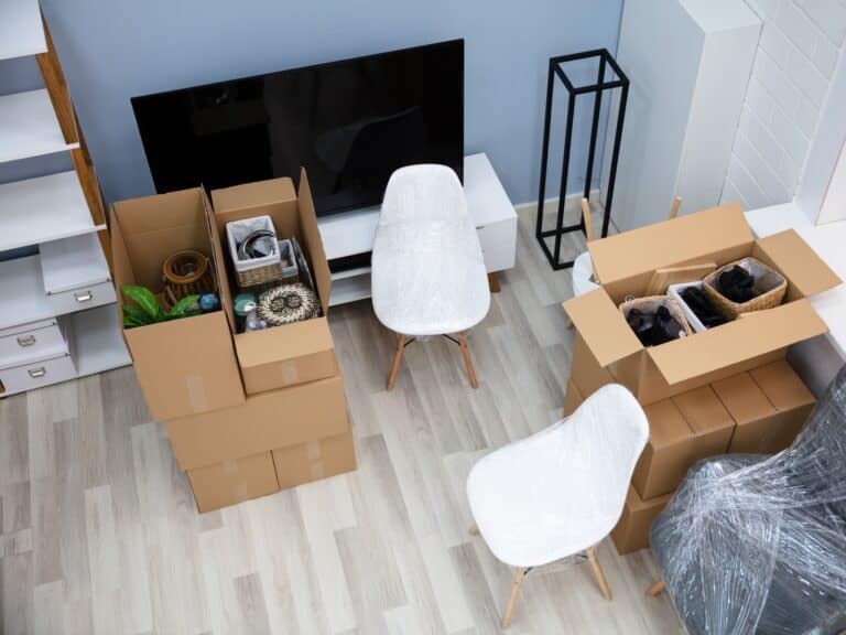View from the stairs of the living room with furnitures and moving boxes at night--getting ready for the move